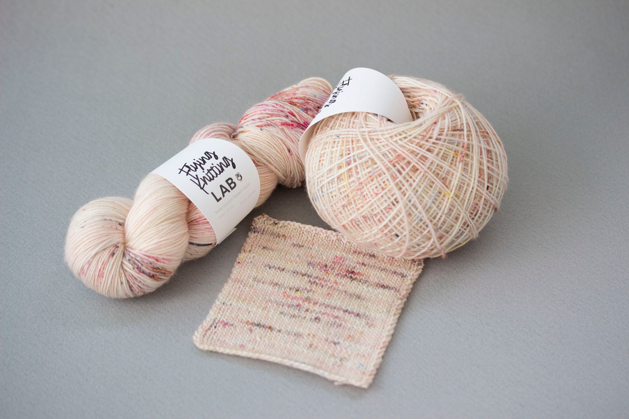 Hand-dyed skein, wound ball, and knitted swatch from Flying Knitting Lab
